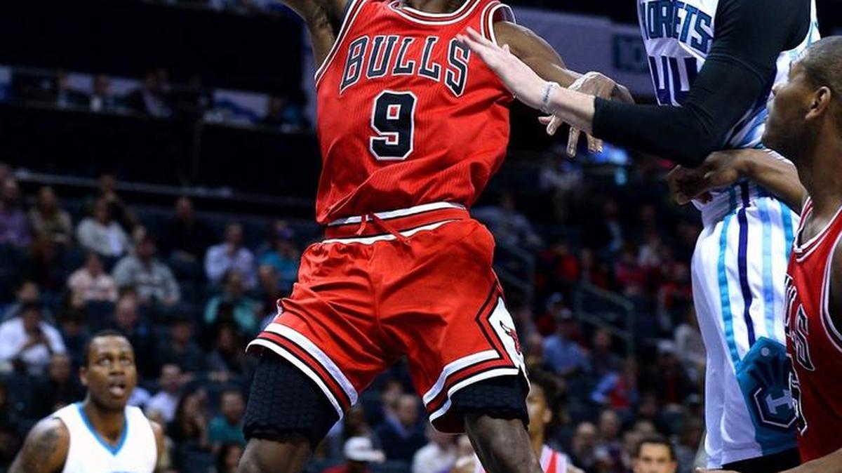 Bulls guard Rajon Rondo gets to the basket for two points as Hornets forward/center Frank Kaminsky attempts to block the shot Monday night at the Spectrum Center.