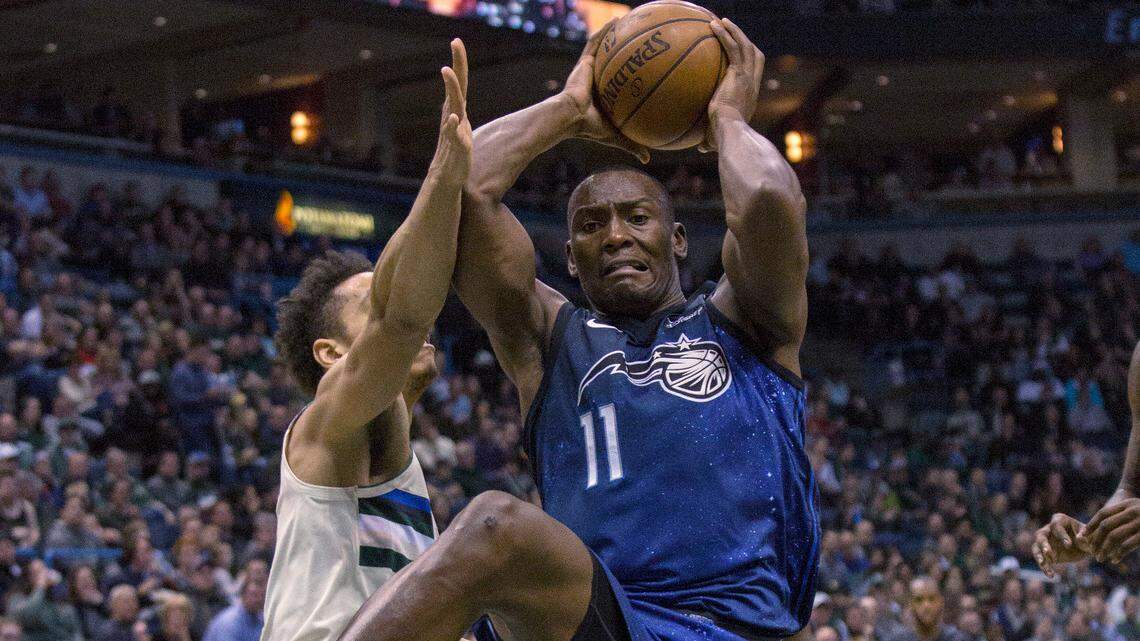 Orlando Magic center Bismack Biyombo, right, goes up for a basket against the defense of Milwaukee Bucks guard Malcolm Brogdon, left, during the first half of an NBA basketball game Monday, April 9, 2018, in Milwaukee. (AP Photo/Darren Hauck)