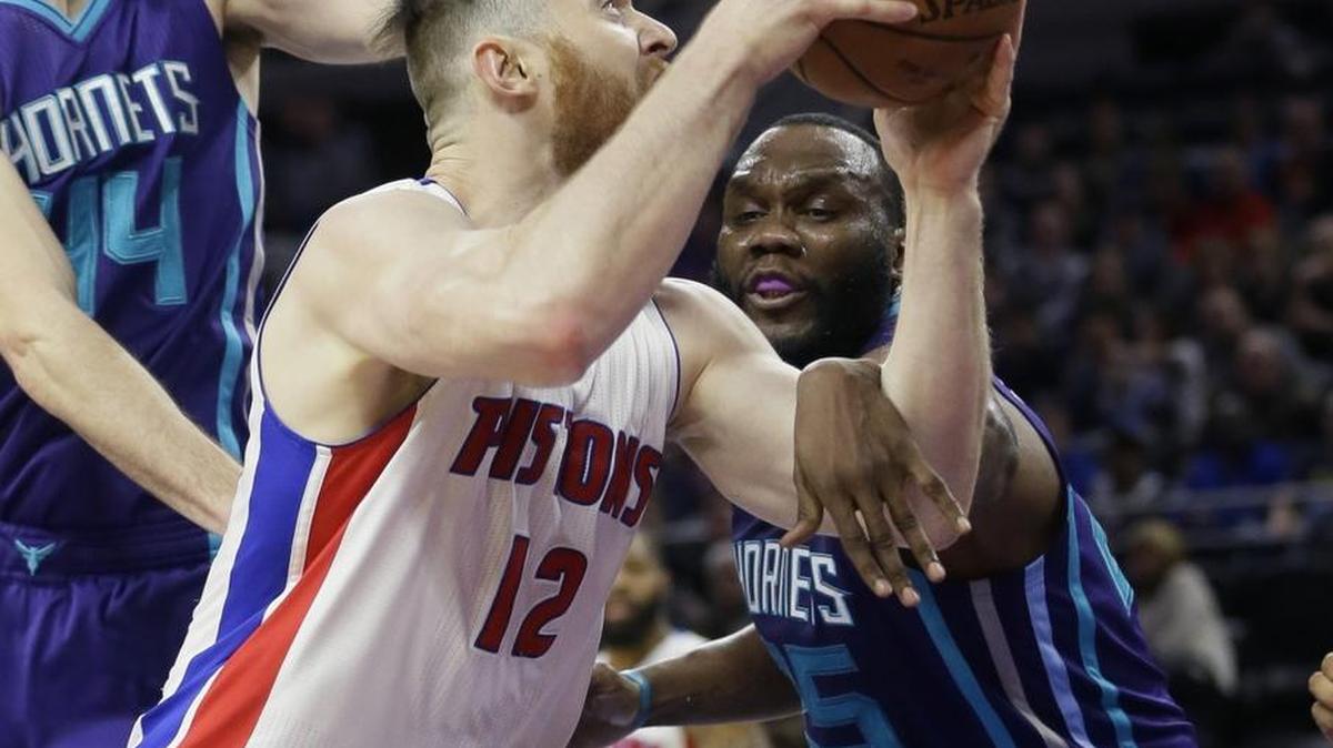 Detroit Pistons center Aron Baynes (12) is fouled by Charlotte Hornets center Al Jefferson (25) during the first half of Friday’s game in Auburn Hills, Mich.