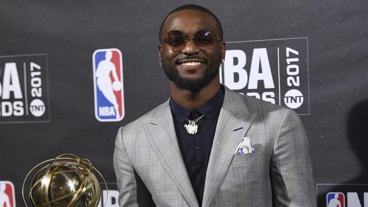 Charlotte Hornets point guard Kemba Walker poses with the trophy for winning the NBA’s annual sportsmanship award.