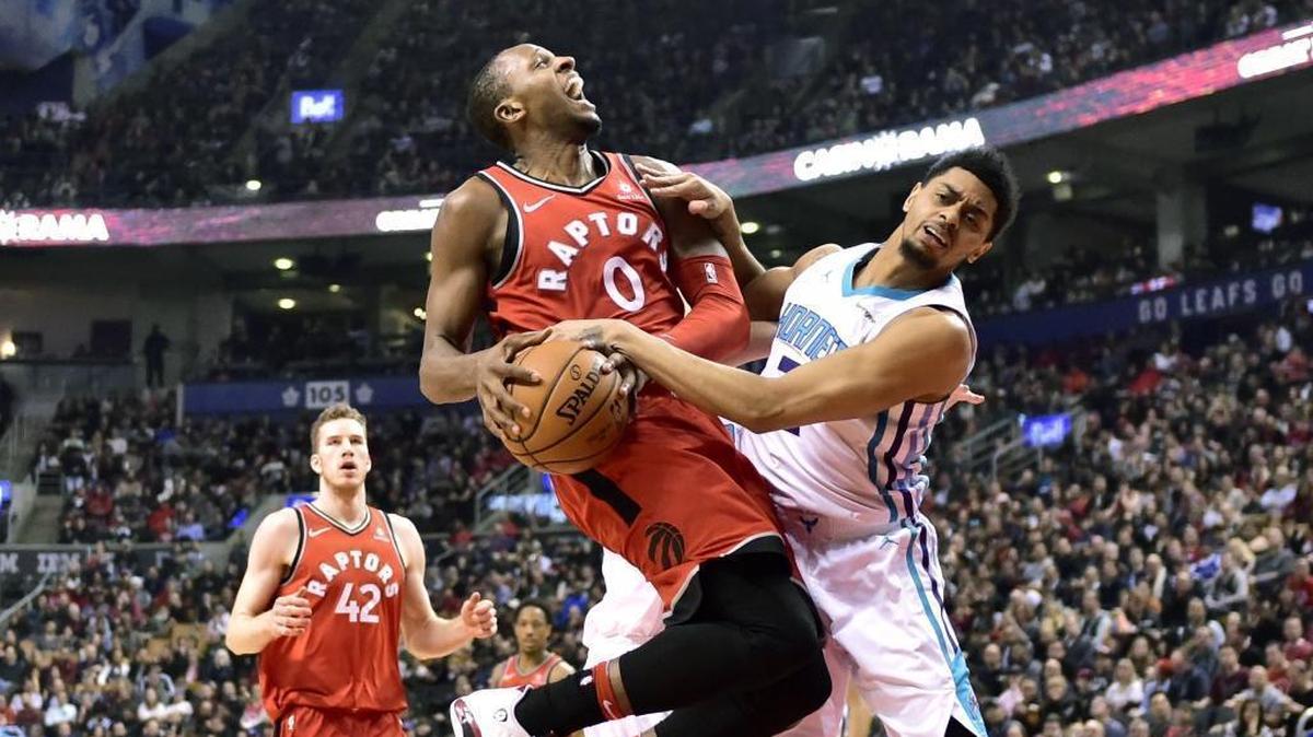 Toronto Raptors forward C.J. Miles (0) collides with Charlotte Hornets guard Jeremy Lamb on his way to the basket during the first half of Sunday’s game.
