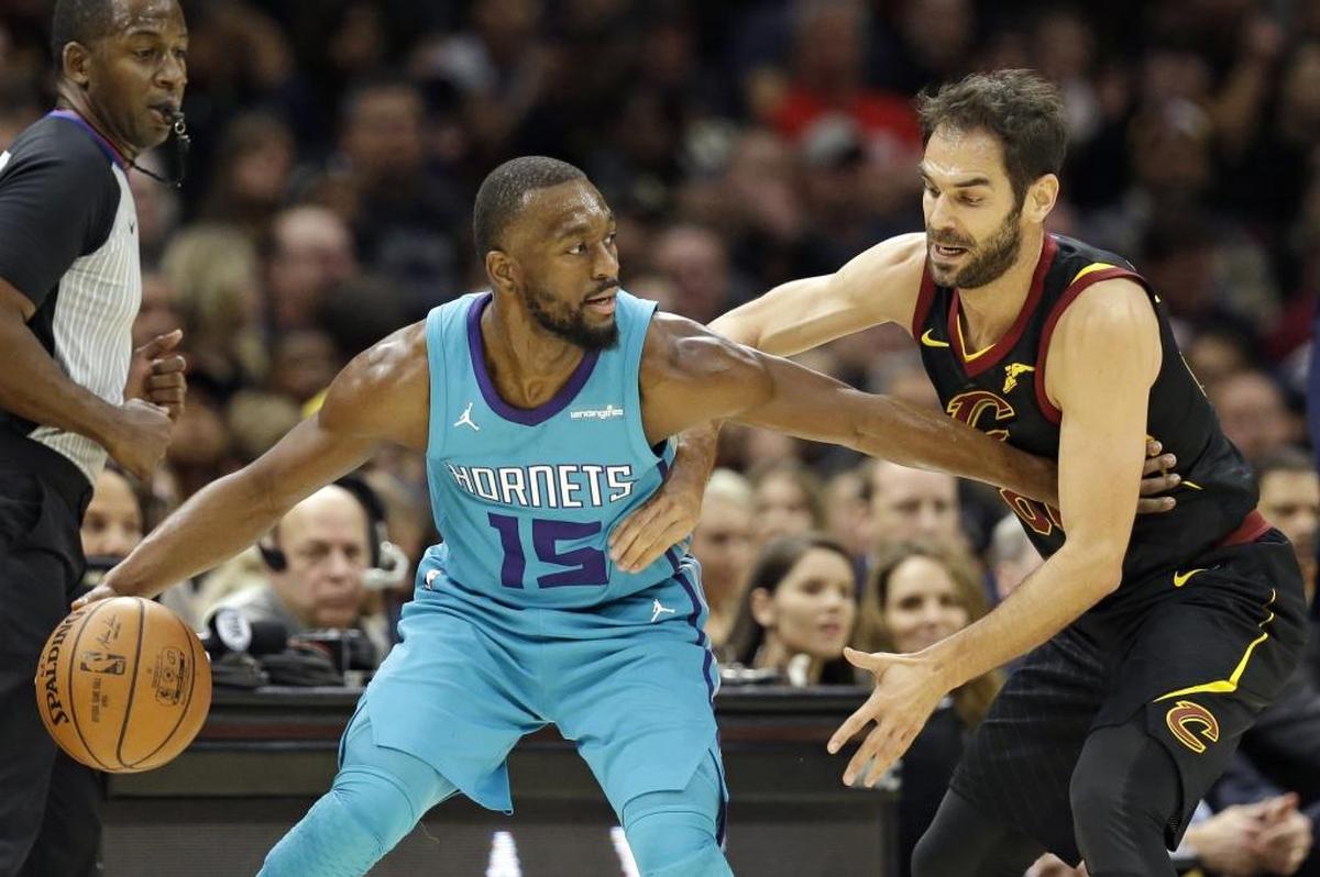 Charlotte Hornets gaurd Kemba Walker, left, drives against the Cleveland Cavaliers' Jose Calderon in the first half of Friday’s game in Cleveland.