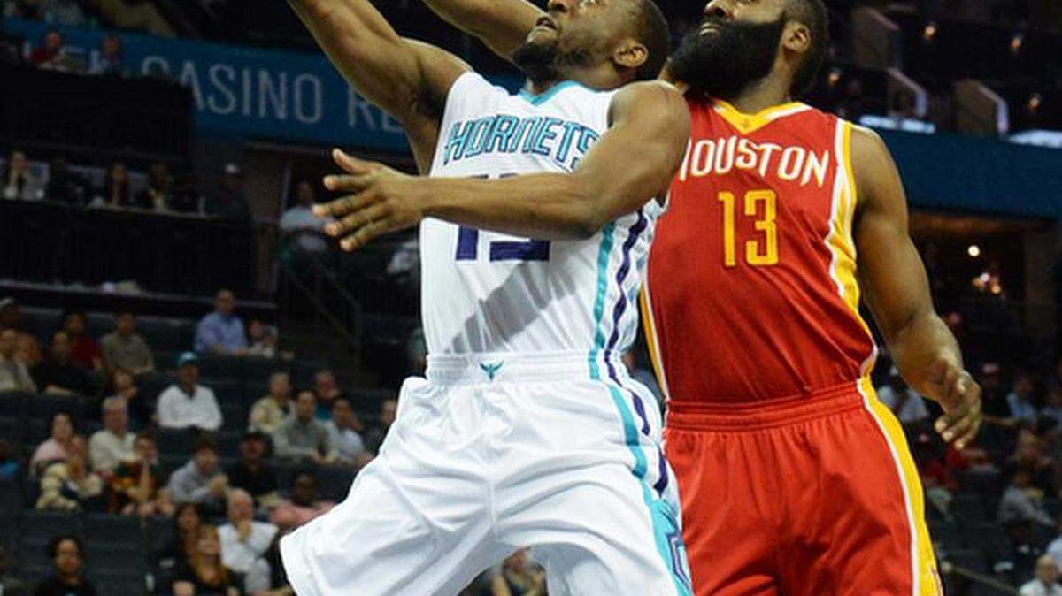 
Charlotte Hornets Kemba Walker (left),carries the ball to the basket against Houston Rockets James Harden (right), during Monday night's game played at Time Warner Cable Arena, April 13,2015.
