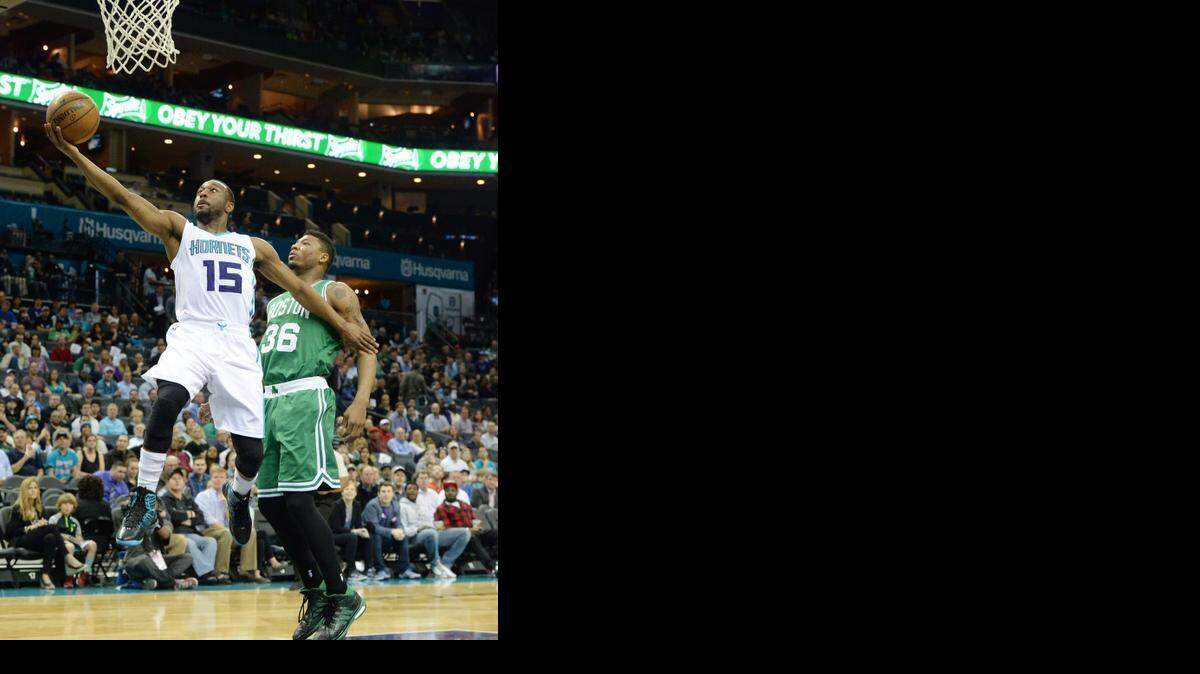 
 Charlotte Hornets Kemba Walker (15)(left), goes for a layup against Boston Celtics Marcus Smart (36)during Monday's game played against the Boston Celtics at Time Warner Cable Arena March 30,2015.
