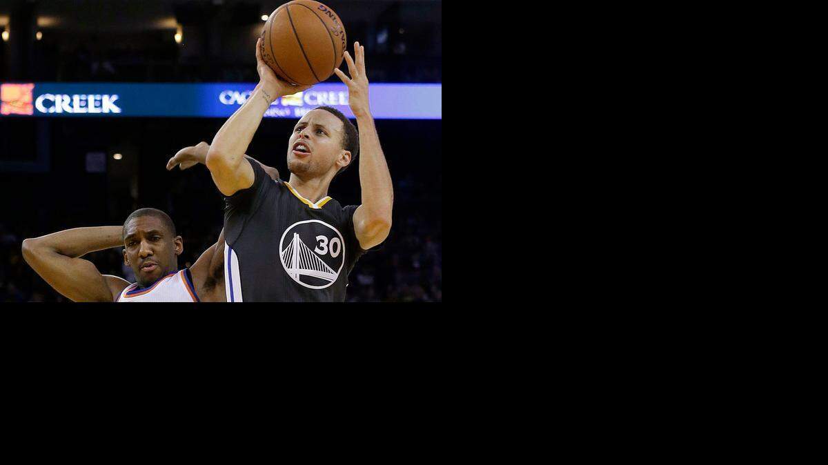 
Golden State Warriors guard Stephen Curry (30) shoots next to New York Knicks guard Langston Galloway (2) during the second half of an NBA basketball game in Oakland, Calif., Saturday, March 14, 2015. The Warriors won 125-94.
