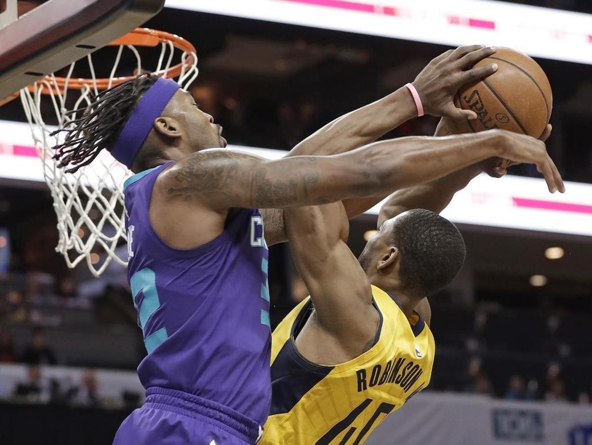 Indiana Pacers' Glenn Robinson III (40) is fouled by Charlotte Hornets guard Julyan Stone, left, during the second half of Sunday’s game at the Spectrum Center.