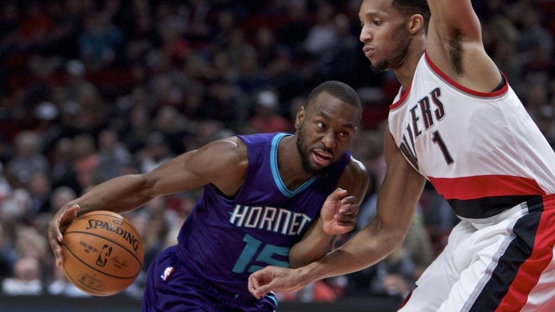 Charlotte Hornets guard Kemba Walker (left) drives on Portland Trail Blazers guard Evan Turner in Tuesday night’s game in Portland, Ore. The Trail Blazers won 115-98, handing the Hornets their fifth consecutive loss.