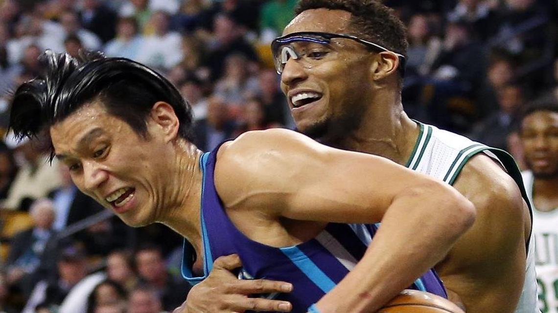Charlotte Hornets' Jeremy Lin, left, battles Boston Celtics' Evan Turner for the ball during the second quarter of an NBA basketball game in Boston Monday, April 11, 2016.
