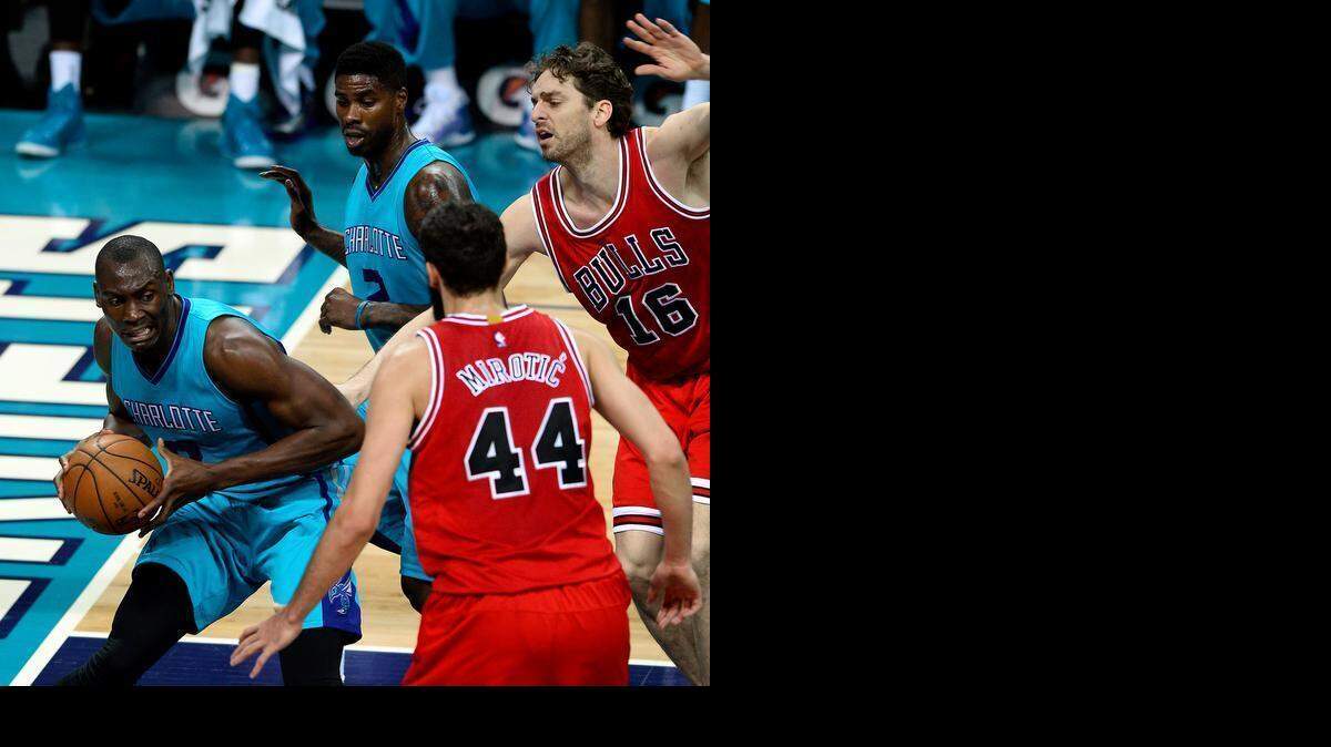 
Charlotte Hornets forward/center Bismack Biyombo (8) fights for position under the basket for a shot as Chicago Bulls forward/center Pau Gasol (16) and forward Nikola Mirotic (44) apply defensive pressure on Friday March 13, 2015 at Time Warner Cable Arena in Charlotte. Looking on is Charlotte Hornets forward Marvin Williams (2).

