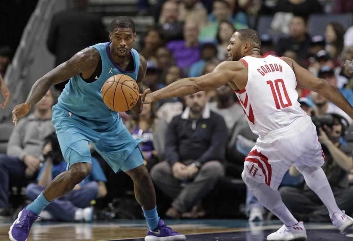 Charlotte Hornets' Marvin Williams, left, steals the ball from Houston Rockets' Eric Gordon, right, during the first half of Friday’s game at the Spectrum Center.