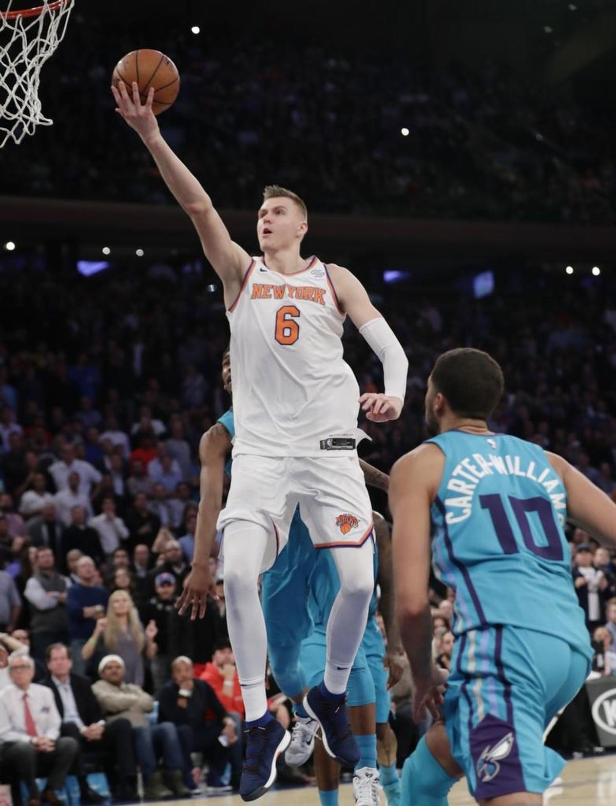 New York Knicks’ Kristaps Porzingis (6) drives past the Charlotte Hornets’ Michael Carter-Williams (10) for two of his game-high 28 points Tuesday night at Madison Square Garden. The Knicks won 118-113 after trailing by as much as 15 points.