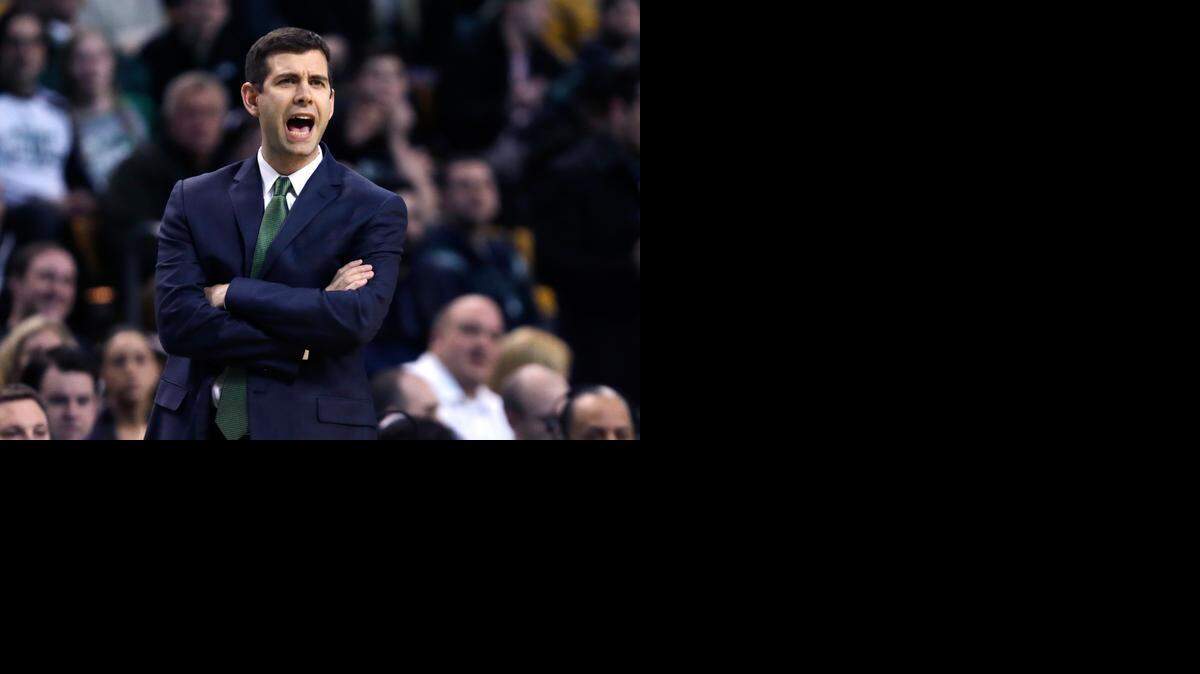 
Boston Celtics head coach Brad Stevens calls to his players while facing the Charlotte Hornets during the first quarter of an NBA basketball game in Boston, Friday, Feb. 27, 2015.
