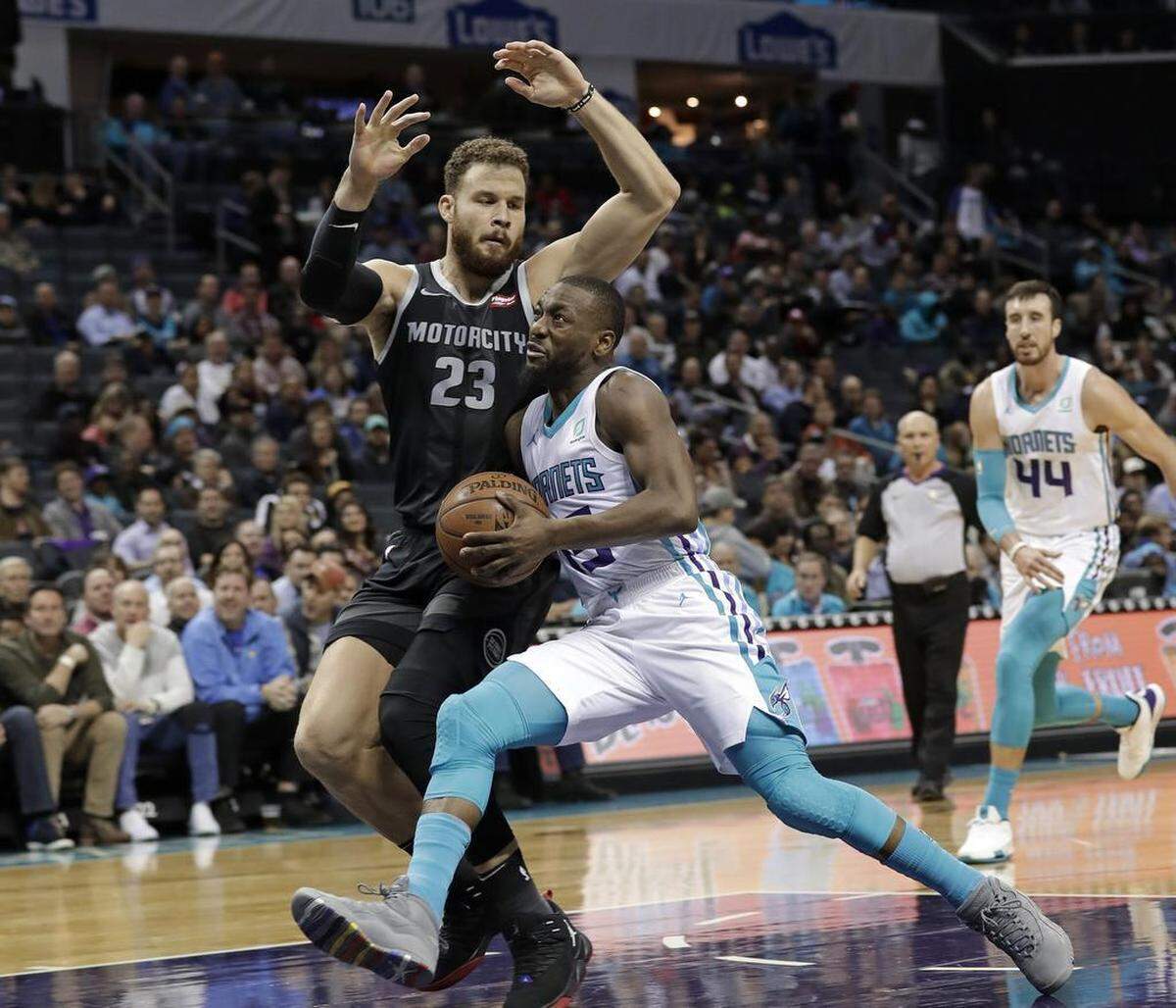 Charlotte Hornets guard Kemba Walker, right, drives against the Detroit Pistons’ Blake Griffin during the first half of Wednesday night’s NBA game at Spectrum Center.