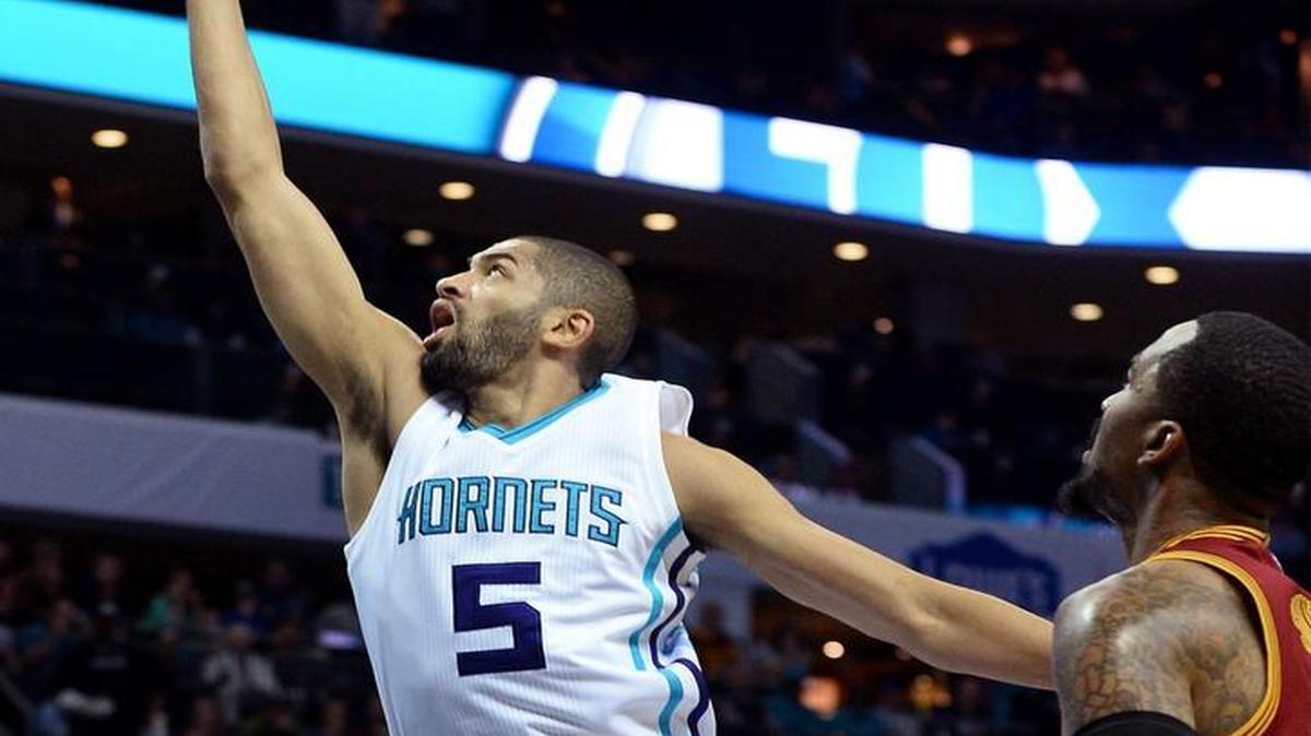 Charlotte Hornets guard Nicolas Batum, left, will probably get help from Michael Kidd-Gilchrist in defending Devin Booker, who scored 70 against Boston on Friday.
