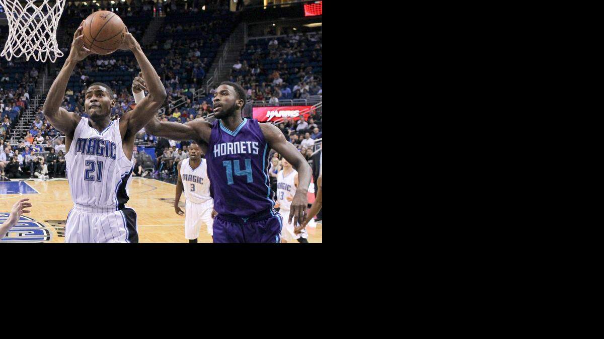
Orlando Magic's Maurice Harkless (21) gets past Charlotte Hornets' Michael Kidd-Gilchrist (14) to shoot during the first half of an NBA basketball game, Sunday, March 1, 2015, in Orlando, Fla. 
