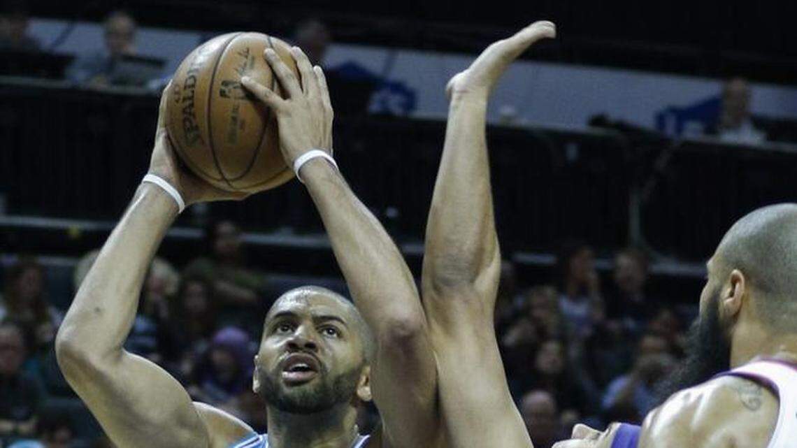 Charlotte Hornets guard Nicolas Batum shoots over Phoenix Suns forward Jared Dudley in the second half of Saturday’s game. Charlotte won 122-115.