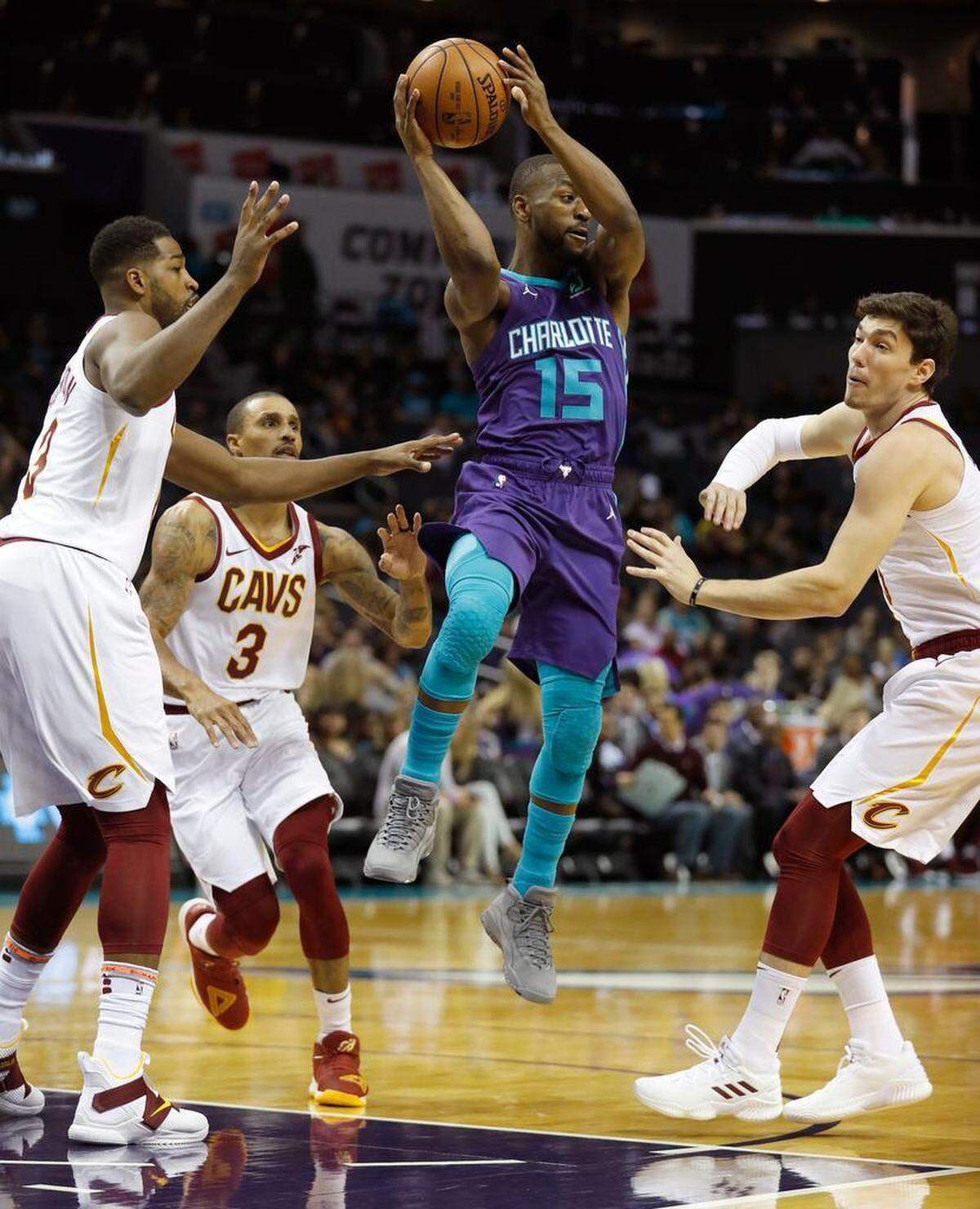 Charlotte Hornets guard Kemba Walker (15) looks to pass while surrounded by the Cleveland Cavaliers’ Tristan Thompson (13), George Hill (3) and Cedi Osman (16) during the first half of Saturday night’s NBA game at the Spectrum Center.