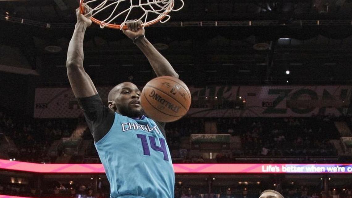Charlotte Hornets' Michael Kidd-Gilchrist (14) dunks past Brooklyn Nets' Brook Lopez (11) in Saturday’s home victory.