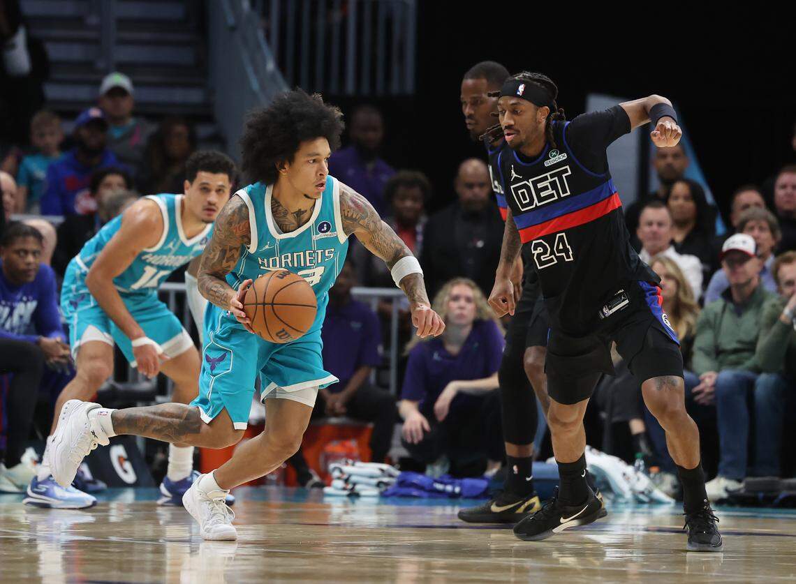 Charlotte Hornets guard Tre Mann drives the ball up the court as Detroit Pistons guard Daniss Jenkins follows the action on Feb. 9, at Spectrum Center in Charlotte.