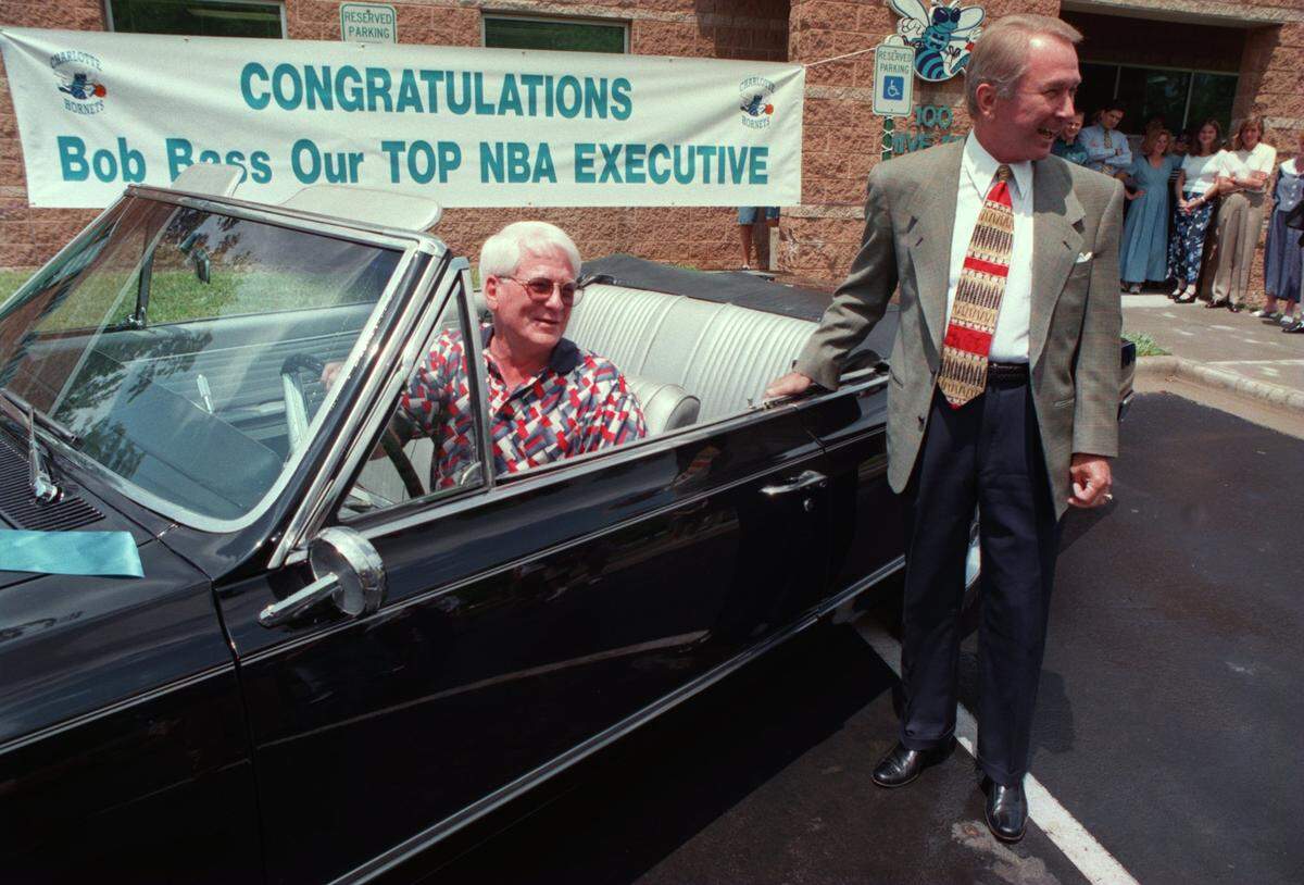 5/21/97 2B T. ORTEGA GAINES/Staff VINTAGE SEASON Bob Bass, the Charlotte Hornets vice president of basketball operations, gets comfortable in the black 1965 Oldsmobile convertible given to him by team owner George Shinn (right) Tuesday as special recognition for being named NBA executive of the year by The Sporting News.   [UNPUBLISHED NOTES:]  (5/20/97 LAYE) George Shinn owner of the Charlotte Hornets presented Bob Bass a classic 1965 Olsmobile for  being honored as top NBA executive of the year. PHOTO BY T. ORTEGA GAINES/ STAFF