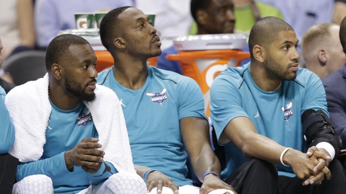 Nicolas Batum (right) got little time to play with Dwight Howard (center) before Batum suffered an elbow injury. Batum said familiarizing himself more with Howard’s game is key right now.