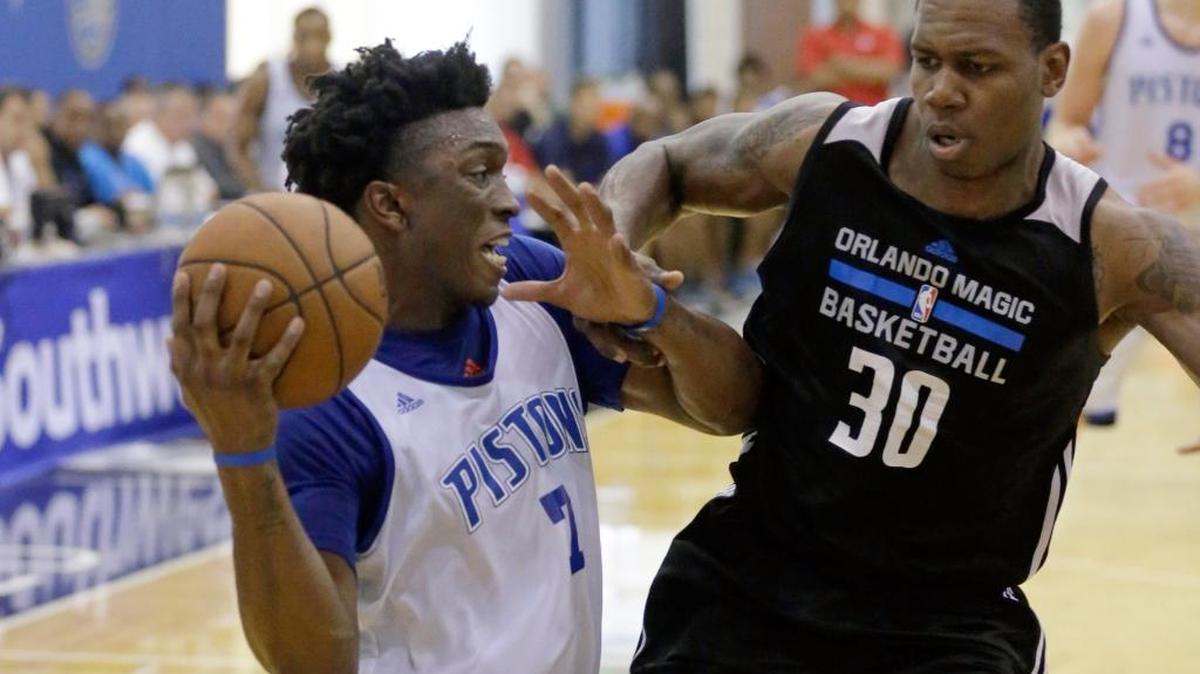 Treveon Graham (30) guards the Detroit Pistons' Stanley Johnson (7) while playing on the Orlando Magic’s summer-league entry.