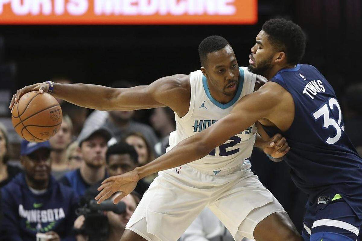 Charlotte Hornets center Dwight Howard (12) protects the ball from Minnesota Timberwolves center Karl-Anthony Towns (32) in the first half of Sunday’s game in Minneapolis. Howard totaled 13 points and nine rebounds.