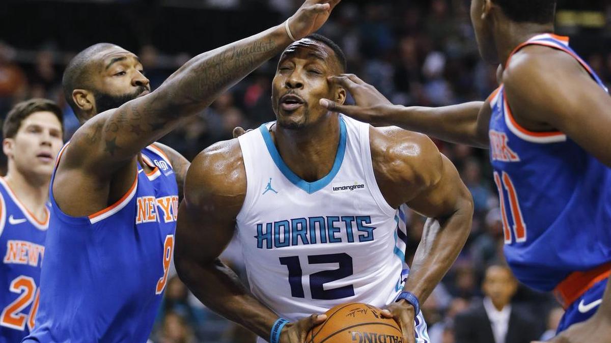 Charlotte Hornets center Dwight Howard (12) works offensively against New York Knicks Kyle O'Quinn, left, and guard Frank Ntilikina during the first half Monday.