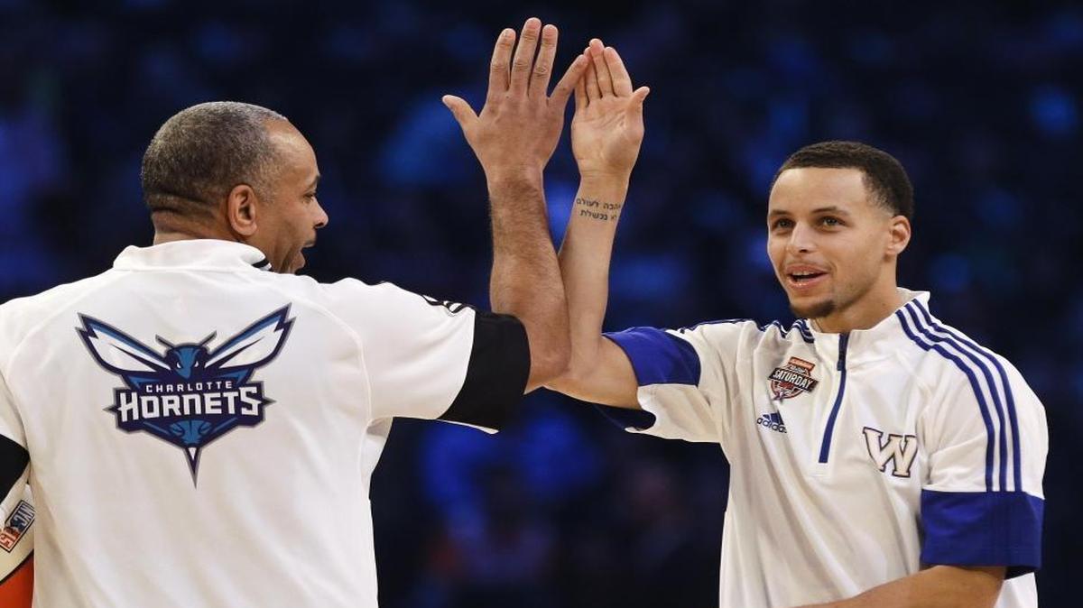 Father Dell Curry (left) and son Stephen share a moment during the NBA All-Star Saturday Shooting Stars event in New York in 2015.