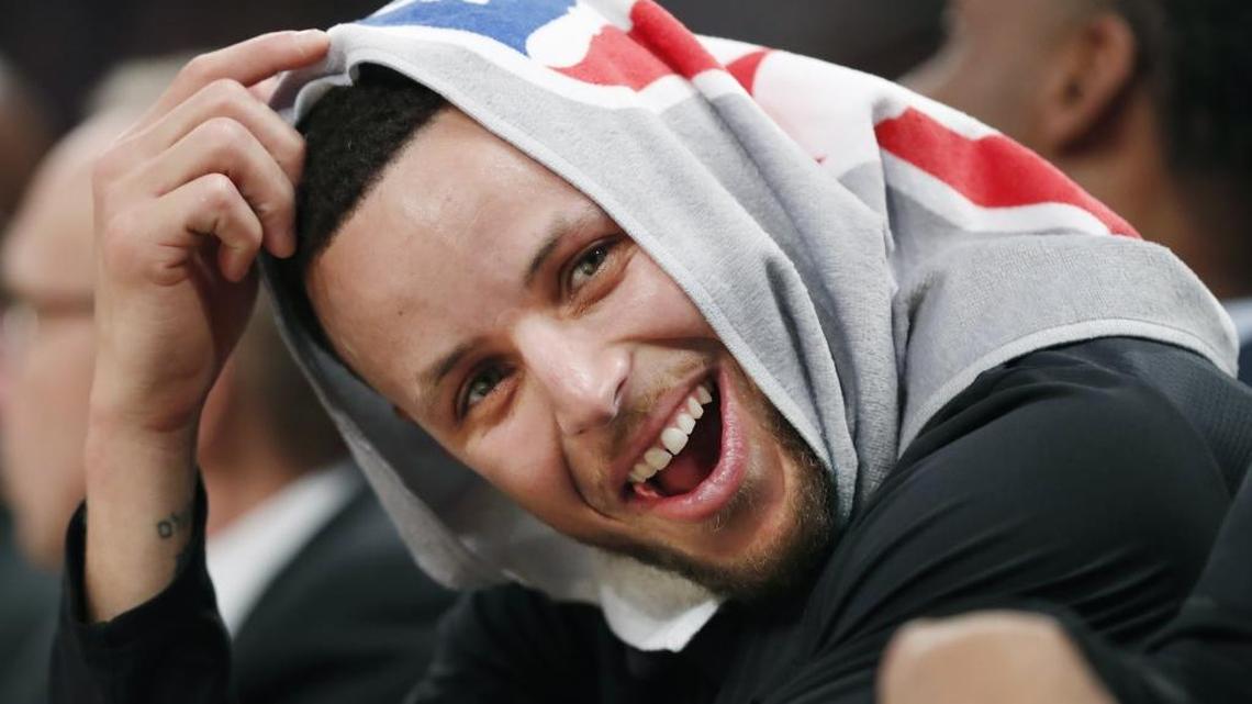 Golden State Warriors guard Stephen Curry, his head covered by a towel, laughs with teammates during a game Feb. 26. On Thursday Curry announced on Twitter that he will serve as an executive producer of the faith-based Hollywood drama, “Breakthrough”