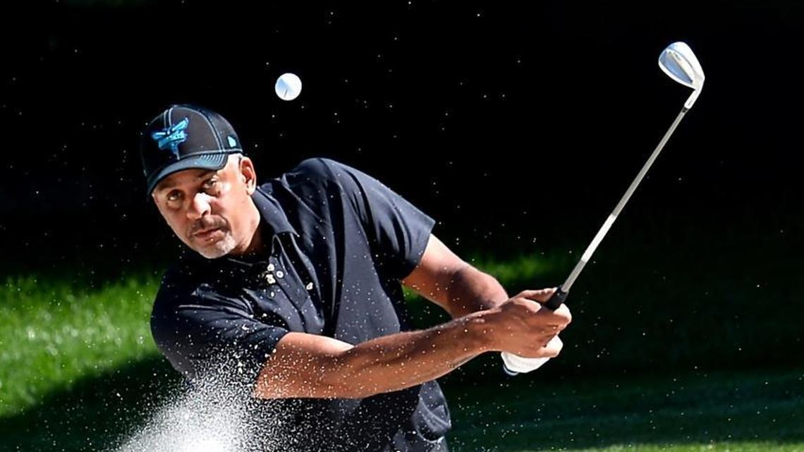 Former Charlotte Hornets star Dell Curry blasts a shot from the bunker on the 15th hole during Wednesday’s Wells Fargo Championship Pro-Am at Quail Hollow Club.