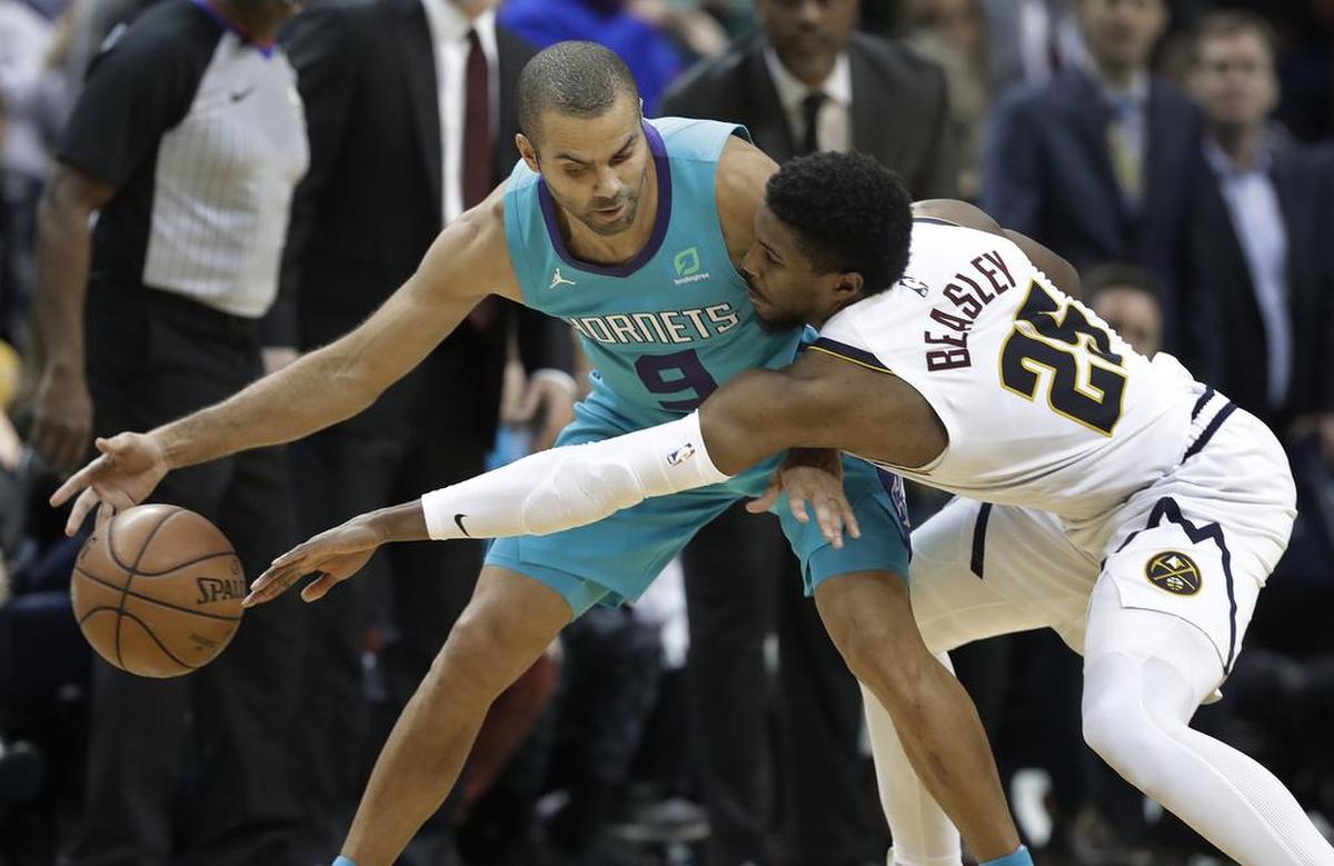 Charlotte guard Tony Parker, left, defended here by Denver’s Malik Beasley, was clutch in the Hornets’ win over the Nuggets Friday night.