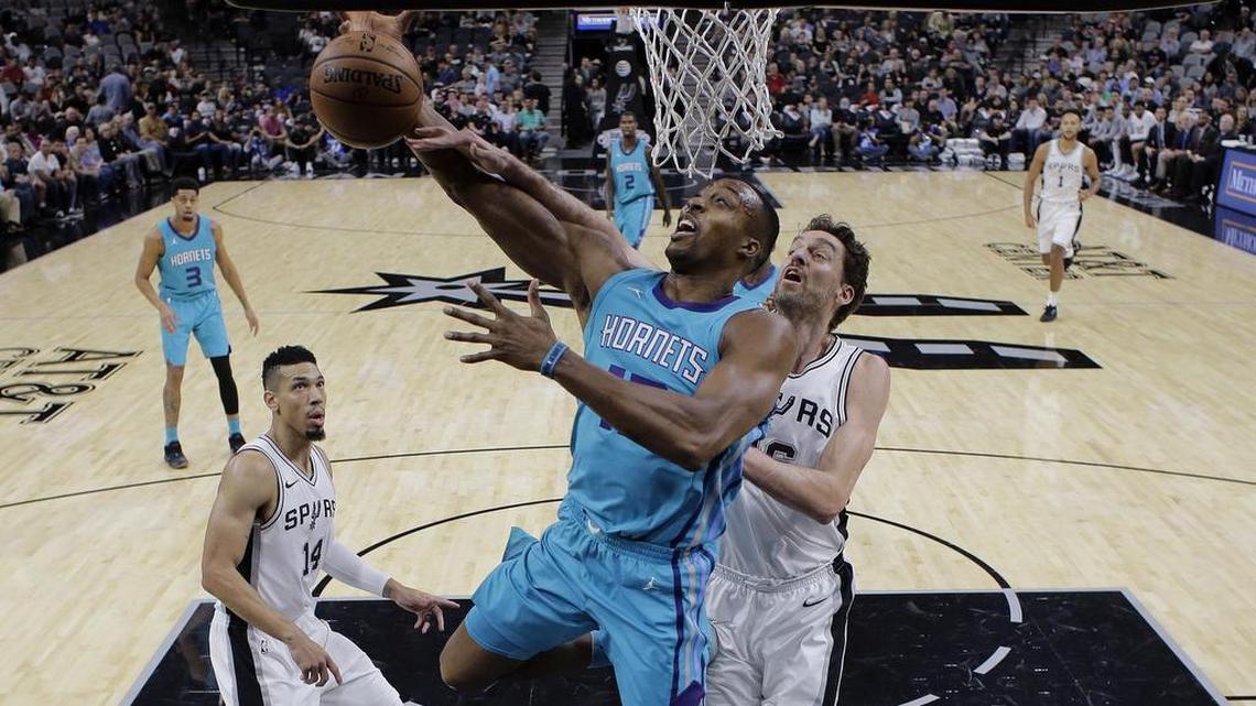 Charlotte Hornets center Dwight Howard (12) is fouled by San Antonio Spurs center Pau Gasol (16) during the first half of Friday’s game at AT&T Center. Howard finished with 20 points and 12 rebounds, but he missed 10 of 20 free throws.