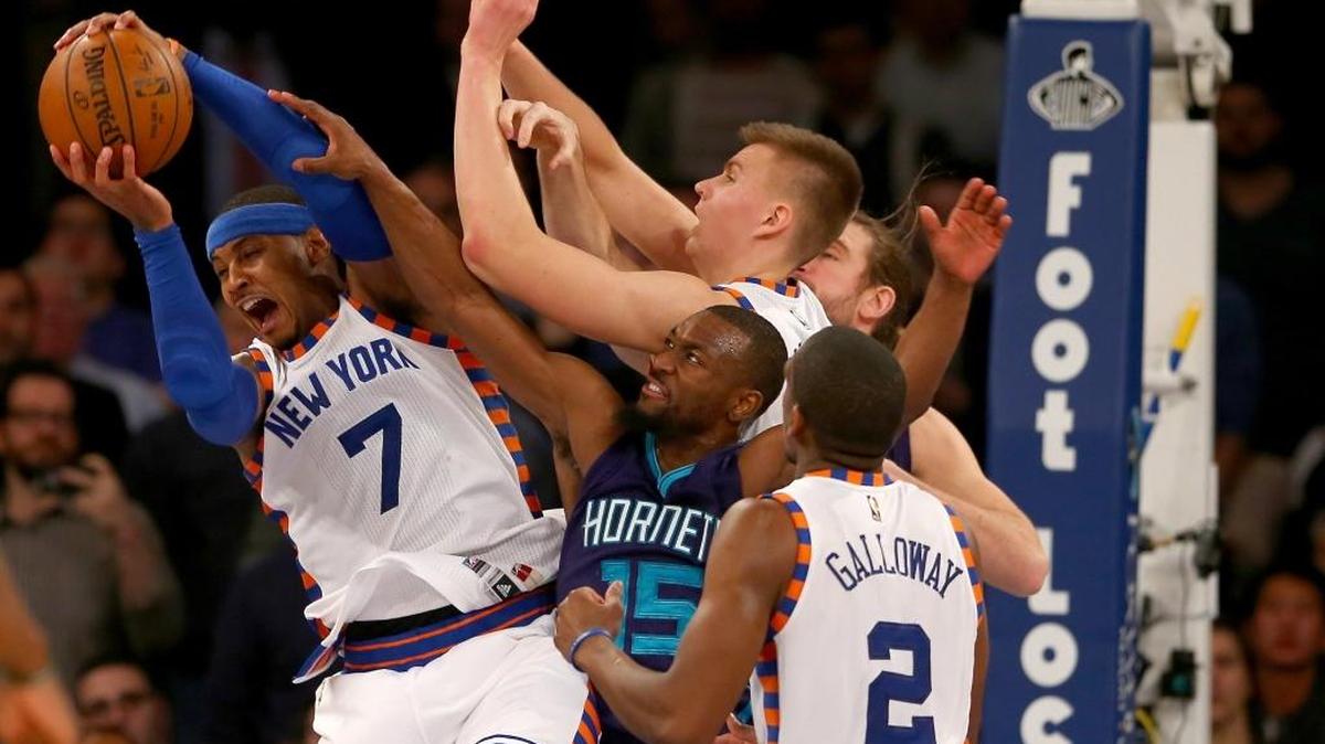 Carmelo Anthony (7), Kristaps Porzingis (6) and Langston Galloway (2) of the New York Knicks fight for the rebound with Kemba Walker (15) and Spencer Hawes, rear, of the Charlotte Hornets. Walker scored a season-high 31 points.