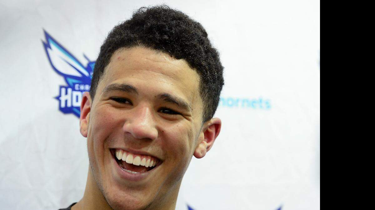 
Devin Booker smiles as he responds to a reporter's question following a pre-draft workout for the Charlotte Hornets on Wednesday, June 10, 2015. Booker played for Kentucky in college.

