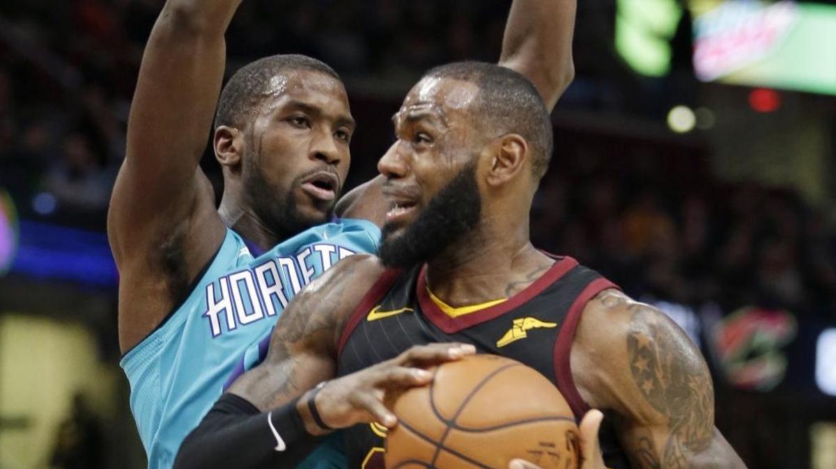 Cleveland Cavaliers' LeBron James, right, drives on Charlotte Hornets' Michael Kidd-Gilchrist in the first half Friday at Quicken Loans Arena.