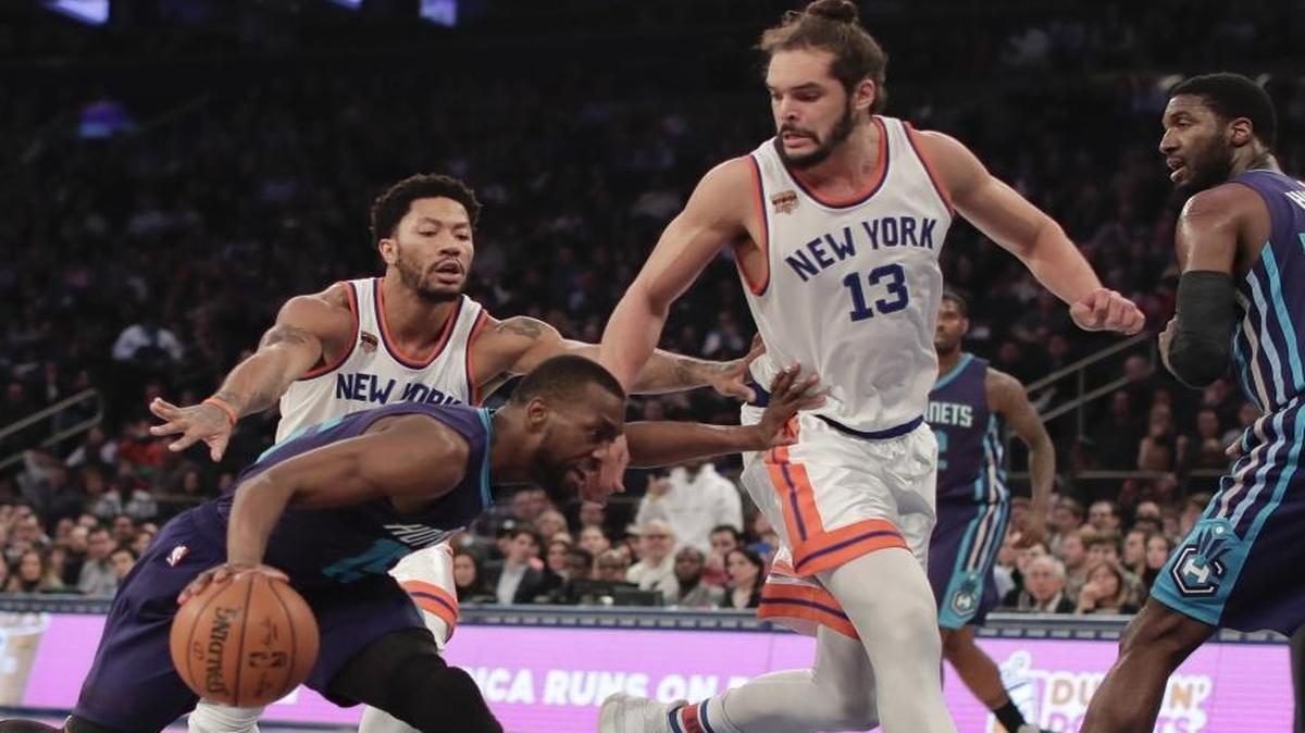 Charlotte Hornets guard Kemba Walker (15) drives against New York Knicks center Joakim Noah (13) and guard Derrick Rose during the first quarter Friday.