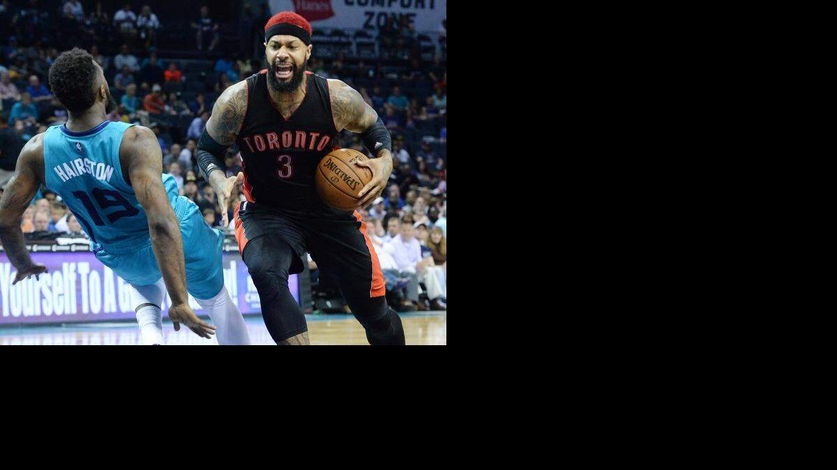 
 Toronto Raptors forward James Johnson, right, presses the ball against Charlotte Hornets guard P.J. Hairston during the April 8, 2015 game at at Time Warner Cable Arena. The teams meet Wednesday night in Toronto for the regular season finale.
