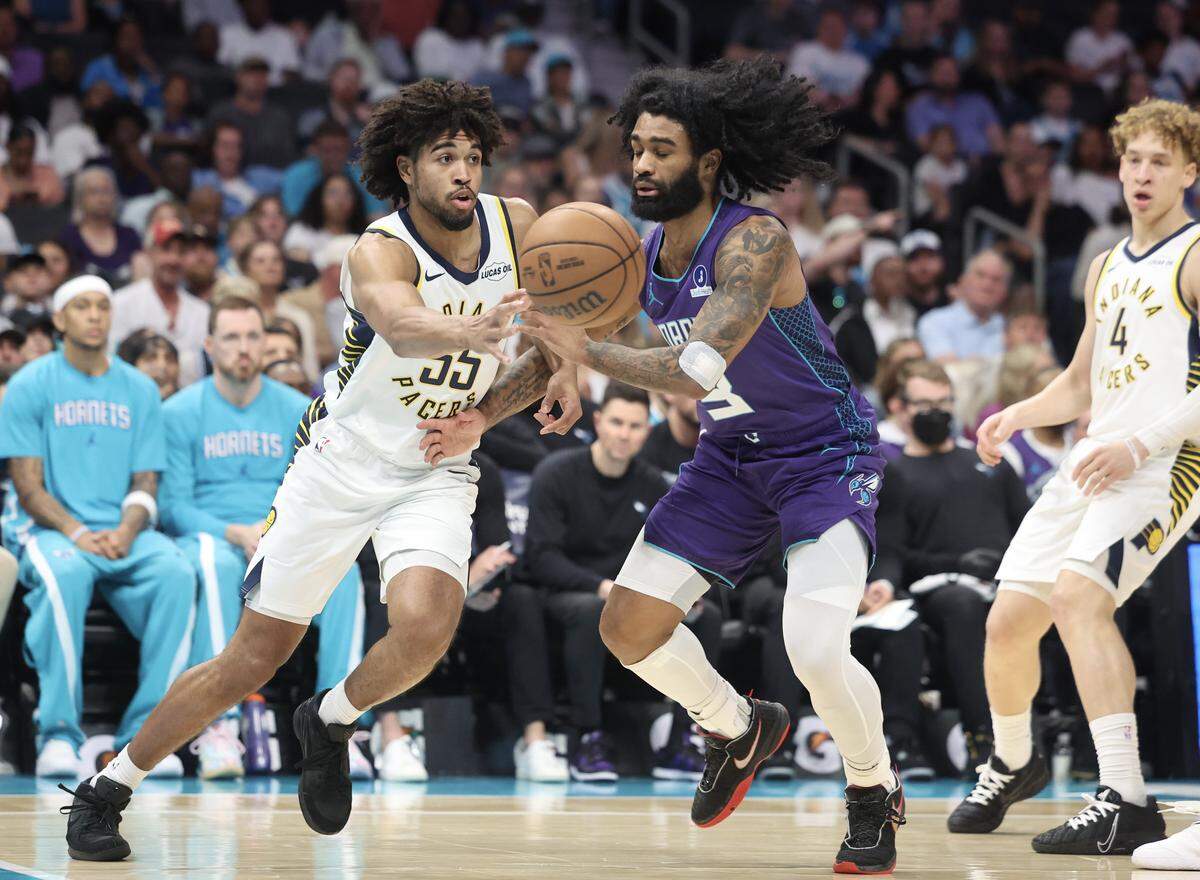 Charlotte Hornets guard Coby White and Indiana Pacers guard Ethan Thompson scramble for a loose ball during the first half of the game Friday, April 3, 2026 at Spectrum Center in Charlotte.