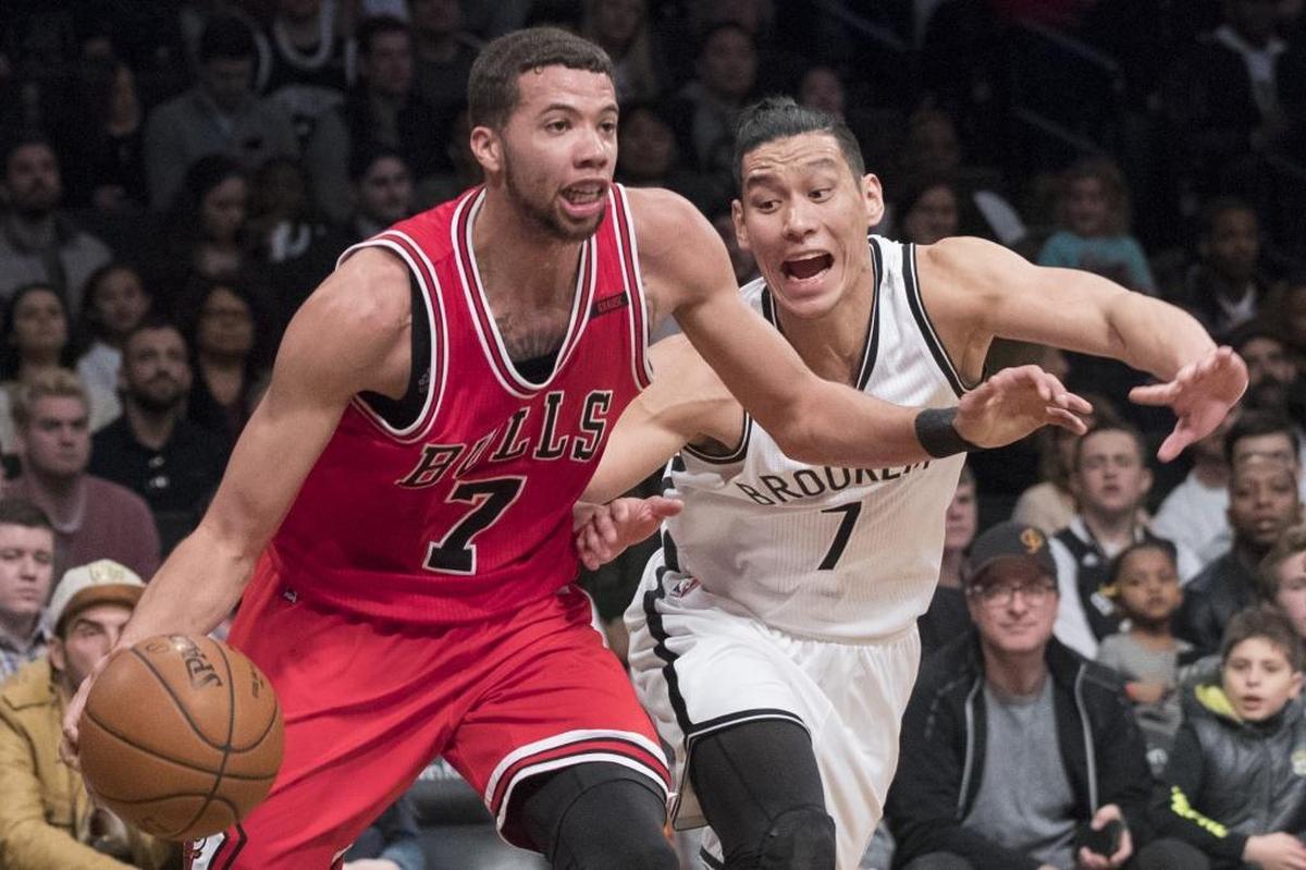 Point guard Michael Carter-Williams, left, drives to the basket against Brooklyn Nets guard Jeremy Lin. With the Hornets, Carter-Williams’ size should complement 6-1 starting point guard Kemba Walker, who was a first-time All-Star last season.