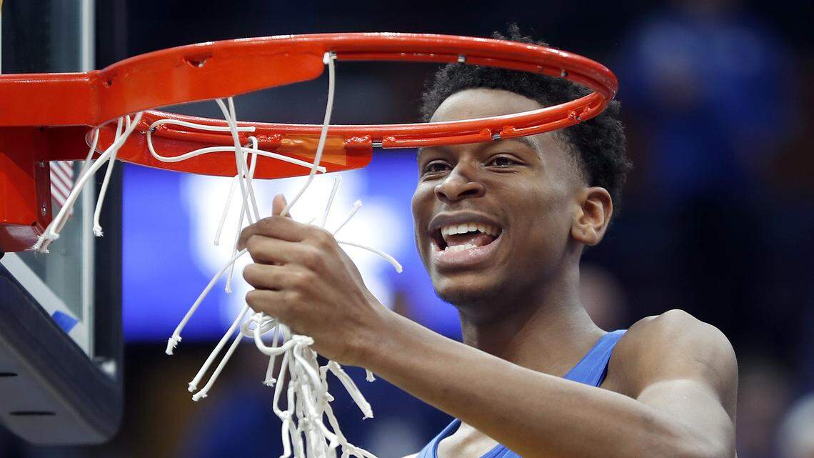 Kentucky guard Shai Gilgeous-Alexander cuts down the net after Kentucky defeated Tennessee 77-72 in an NCAA college basketball championship game at the Southeastern Conference tournament Sunday, March 11, 2018, in St. Louis. (AP Photo/Jeff Roberson)