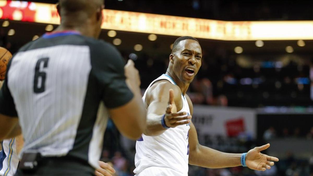 Charlotte Hornets center Dwight Howard, right, argues a call with referee Tony Brown while facing the Denver Nuggets at Spectrum Center Wednesday.