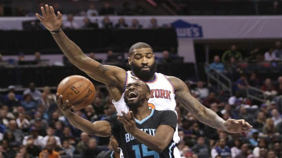 Charlotte Hornets' Kemba Walker (15) drives past New York Knicks' Kyle O'Quinn (9) in the first half of Saturday’s game.