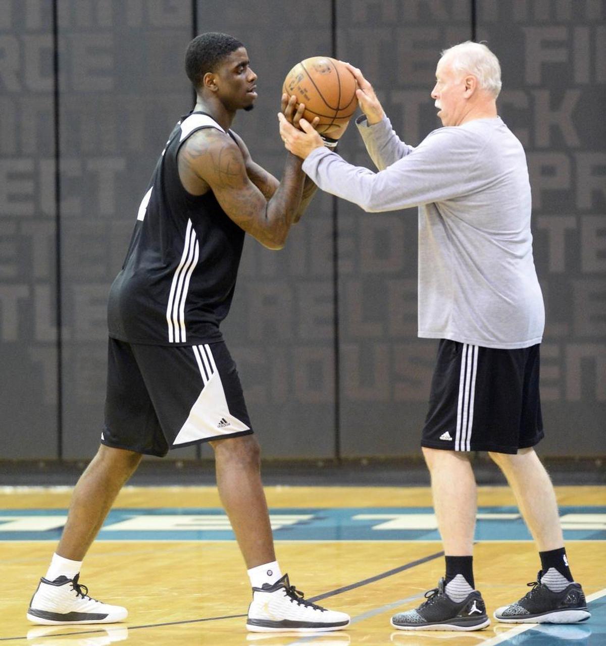 Charlotte Hornets Dwayne Bacon receives instruction from assistant coach Bruce Kreutzer after practice Wednesday at the Spectrum Center.