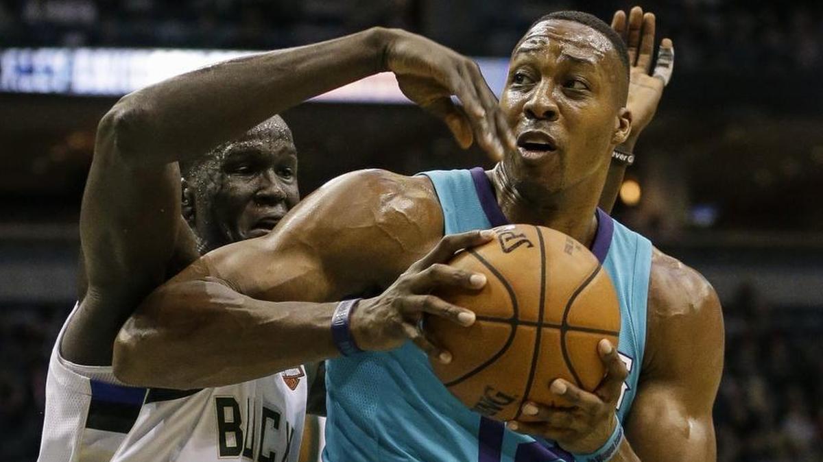Charlotte Hornets' Dwight Howard (with ball) dominated the rebounding Monday, and got the Milwaukee Bucks' Thon Maker in foul trouble early in the second half.