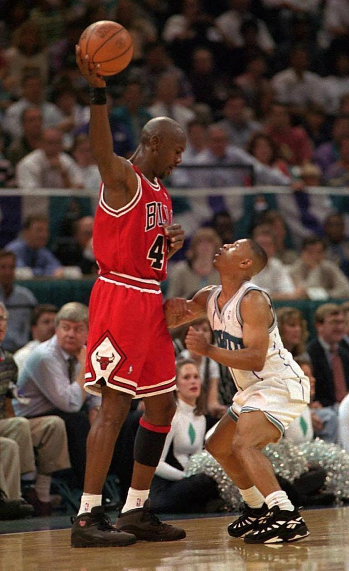 Michael Jordan squares off against Charlotte Hornets star Muggsy Bogues during the 1995 playoffs.