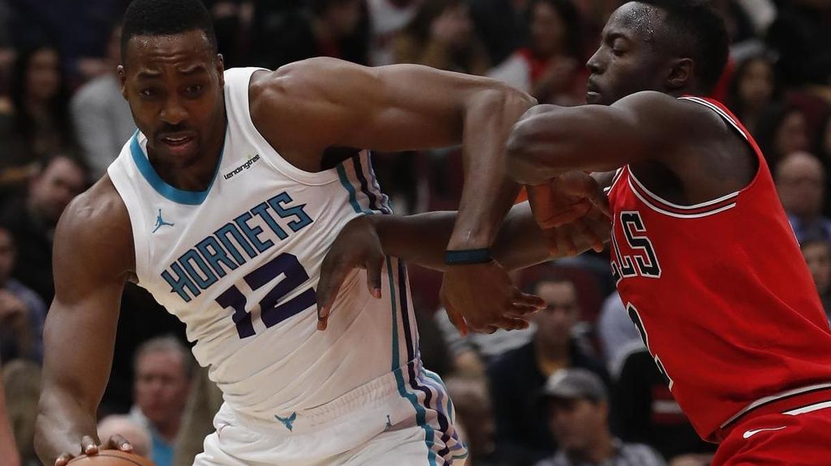 Charlotte Hornets center Dwight Howard works in the post, guarded by the Chicago Bulls' Jerian Grant during the first half of Friday’s NBA game in Chicago.