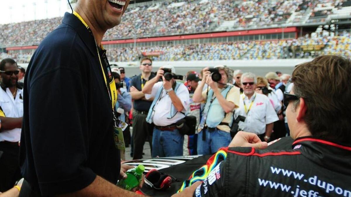Former North Carolina star Brad Daugherty (left) has a second career in NASCAR. Here he speaks with driver Jeff Gordon (right).