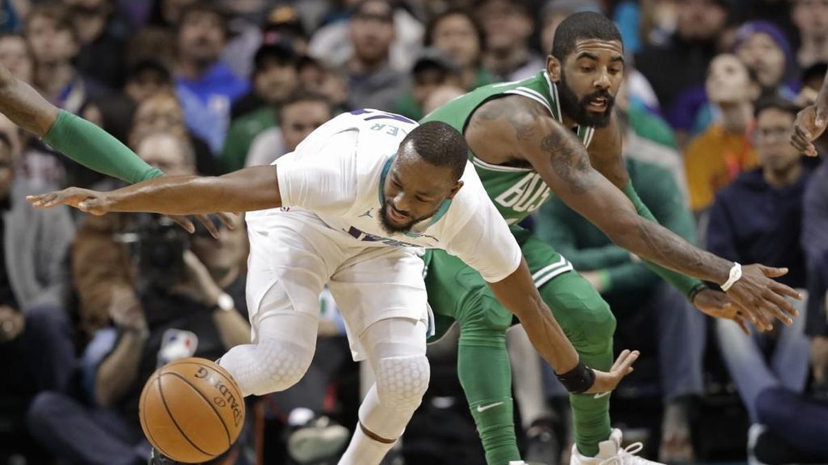 Boston Celtics point guard Kyrie Irving, right, finished with a team-high 21 points Wednesday, but they poured in a different way each time: tough layups, deep 3-pointers and the improvised midrange shots when nothing else was available.