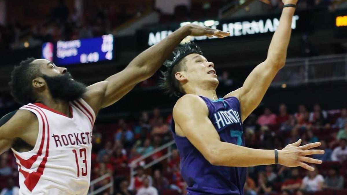 Jeremy Lin #7 of the Charlotte Hornets shoots over James Harden #13 of the Houston Rockets during their game at Toyota Center on December 21, 2015 in Houston, Texas.